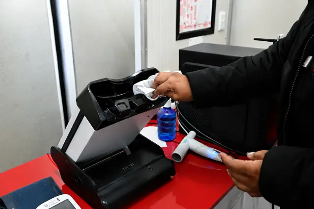 A Care Net clinician sanitising spirometry equipment between medicals.
